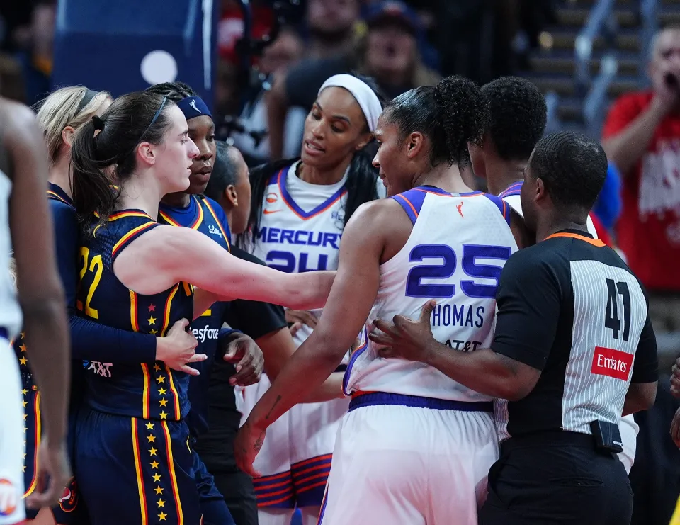Indiana Fever guard Caitlin Clark (22) and Phoenix Mercury forward DeWanna Bonner (24) are separated by a referee on June 22, 2026