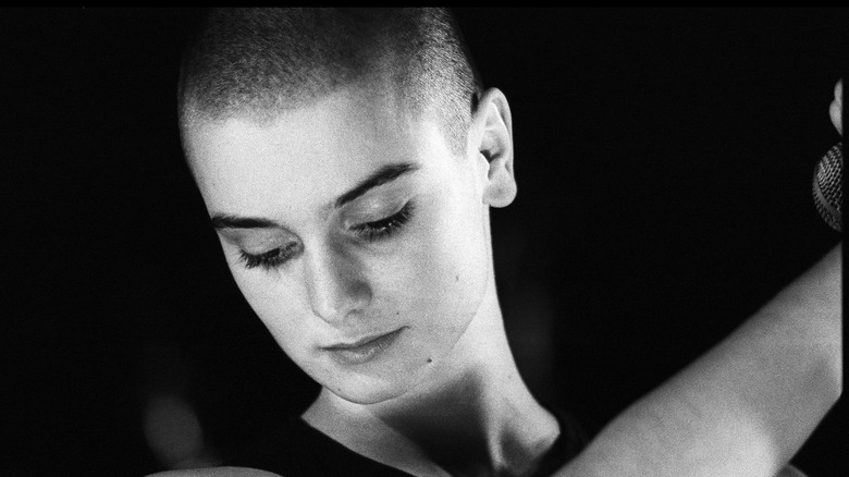 Sinead O'Connor looking down as she performs