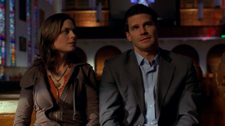 Temperance Brennan looking at Seeley Booth while sitting in a church