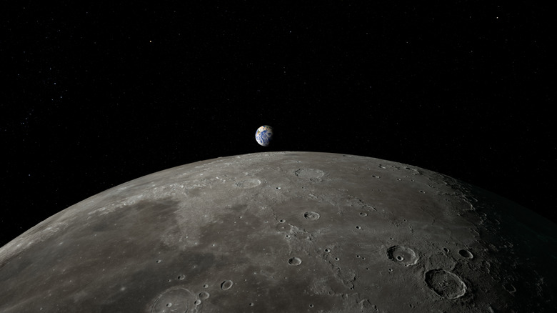 surface of the moon with the earth visible in the background