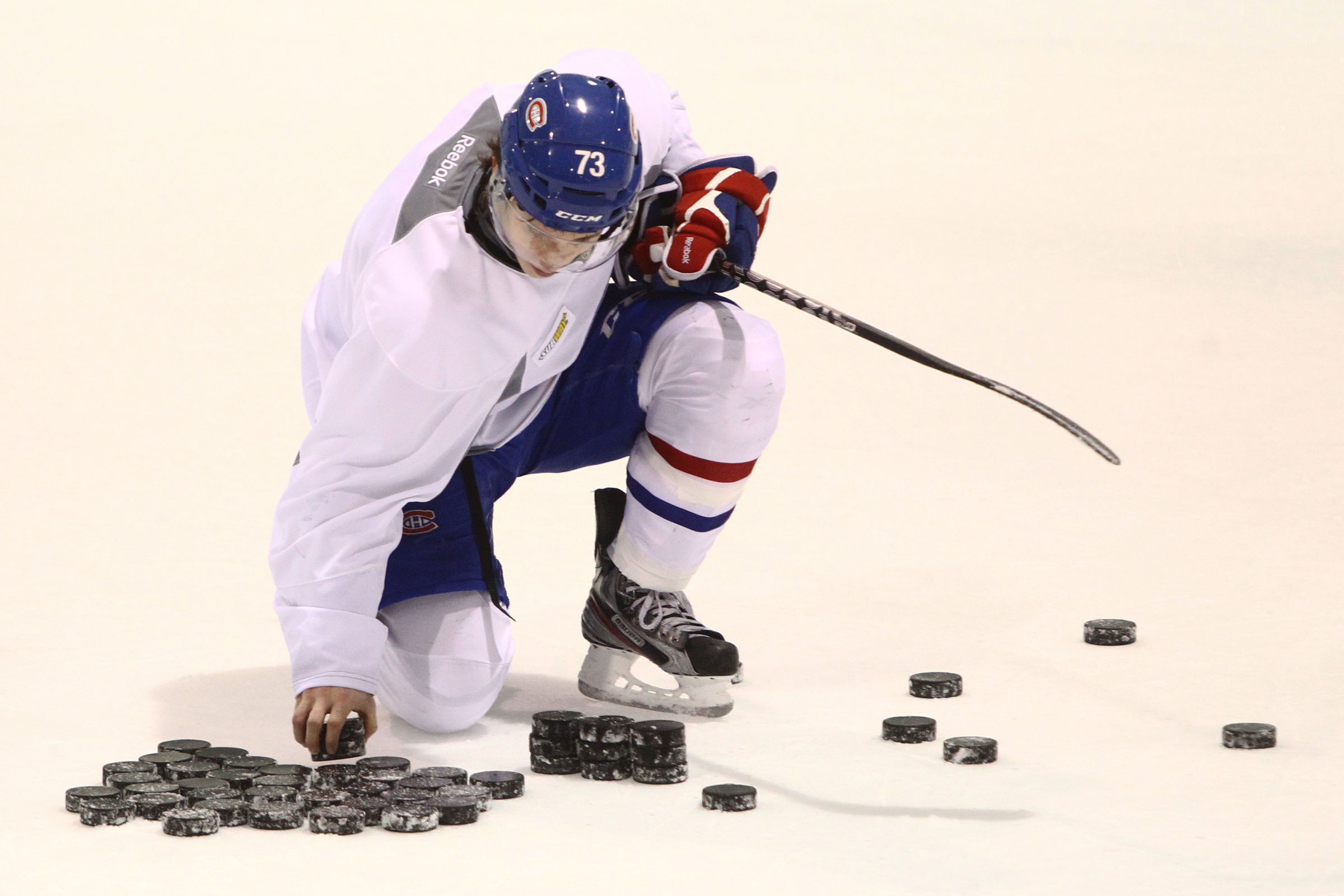 Brendan Gallagher picks up some pucks on the ice.