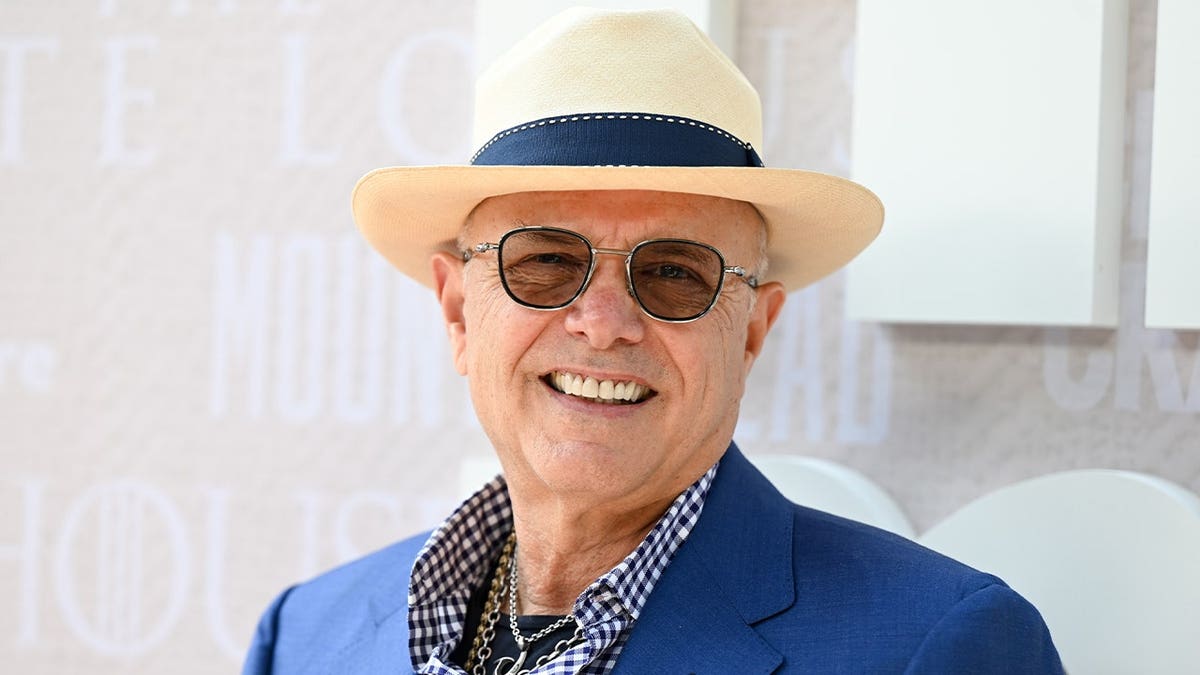 Joe Pantoliano wears a hat and blue blazer