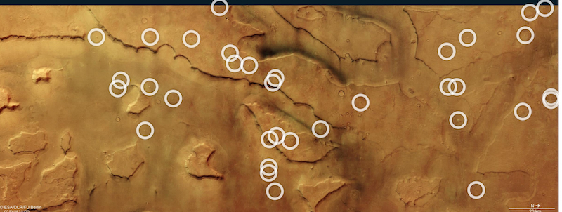 Reddish terrain viewed from above with 34 white circles, some overlapping.