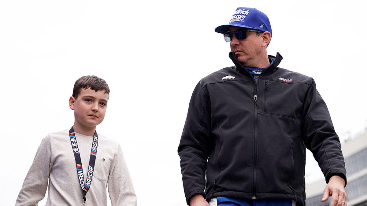 Kyle Busch and son Brexton Busch walking onstage at Echo Park Speedway