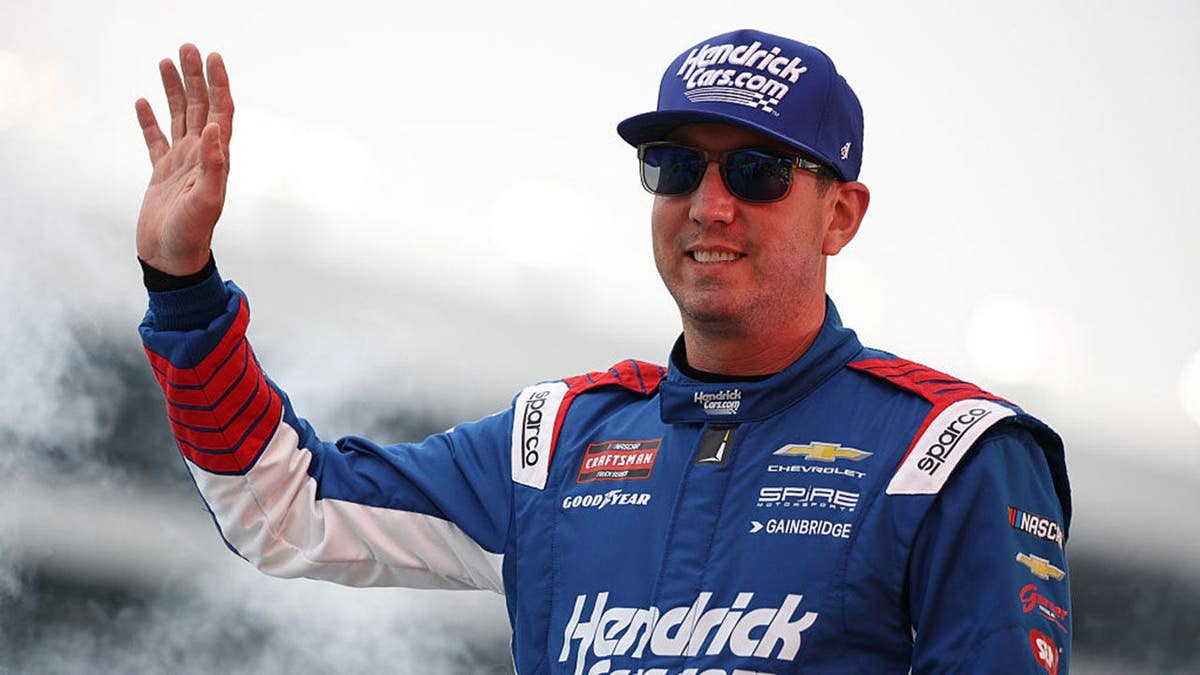 Kyle Busch standing in racing suit at Texas Motor Speedway