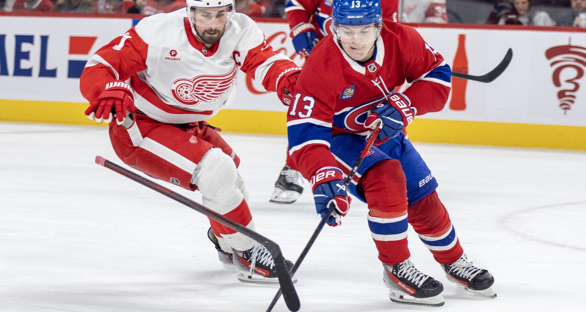 Detroit Red Wings centre Dylan Larkin loses his stick while forechecking Canadiens winger Cole Caufield during second period in Montreal on April 8, 2025.
