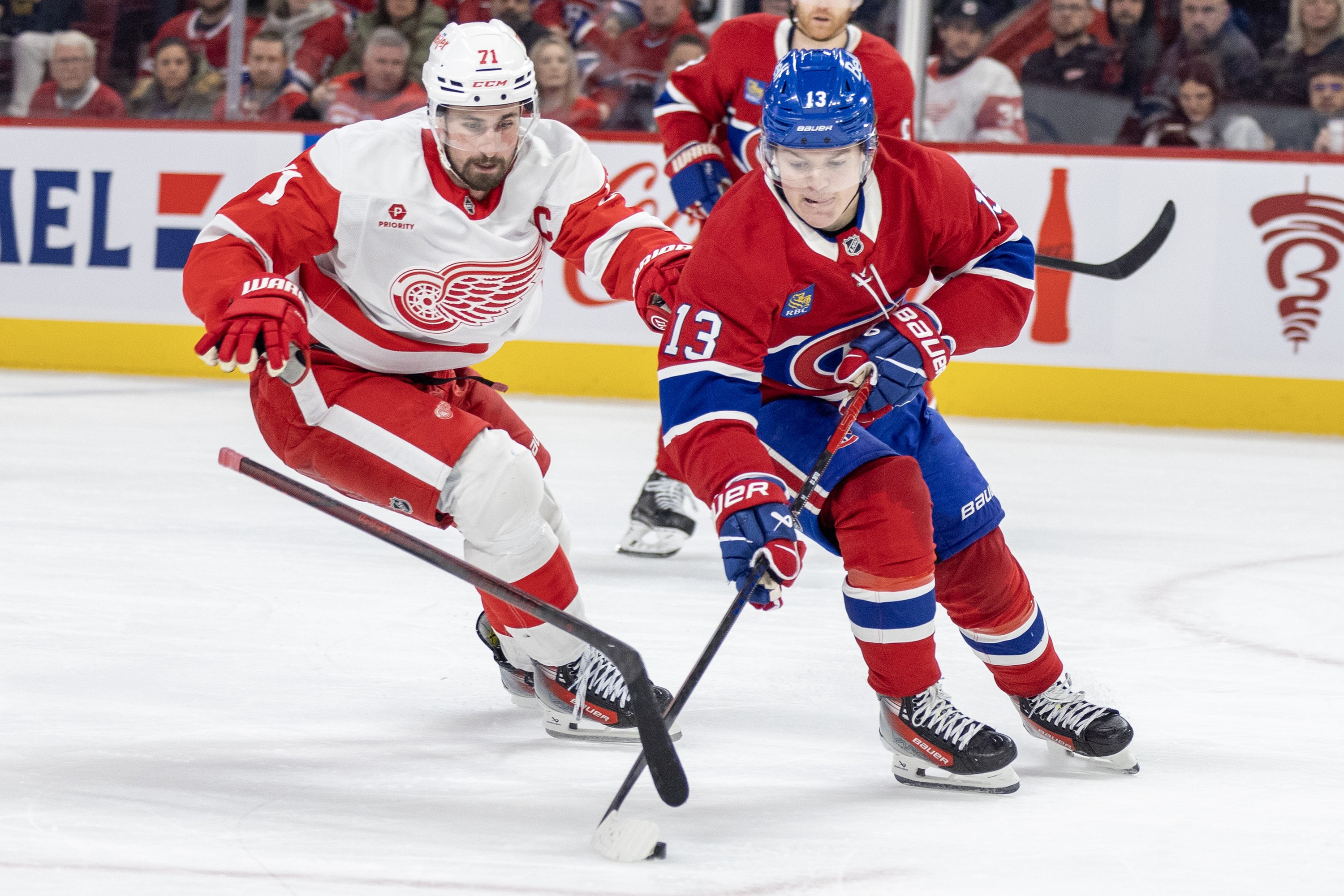 Detroit Red Wings centre Dylan Larkin loses his stick while forechecking Canadiens winger Cole Caufield during second period in Montreal on April 8, 2025.