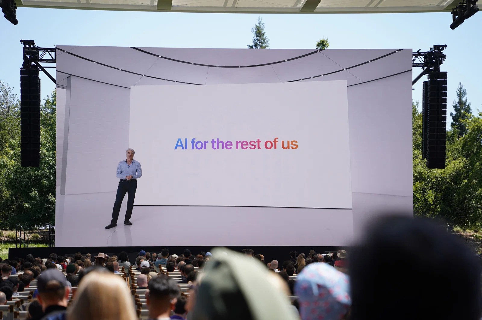 Photo from 2024 WWDC keynote featuring a tagline that reads “AI for the rest of us”