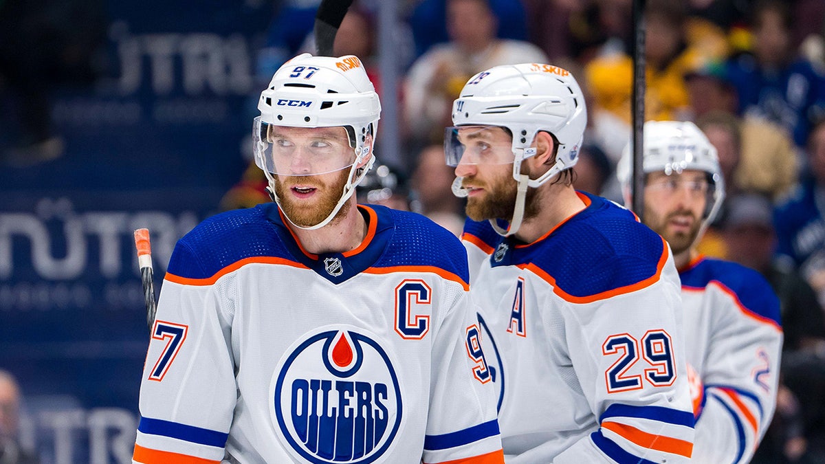 Edmonton Oilers forward Connor McDavid and forward Leon Draisaitl and defenseman Evan Bouchard on ice during a hockey game