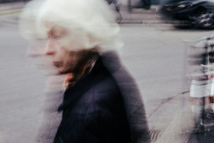 Blurred image of elderly woman walking, symbolizing dementia effects