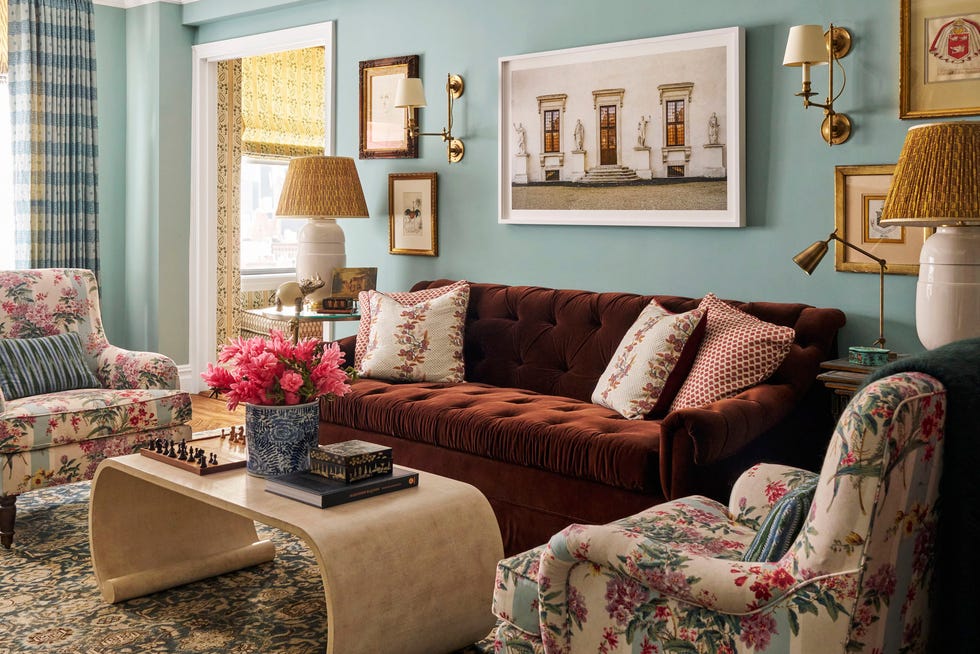 Meredith Ellis New York Apartment Living Room living room with solid colored couch, chairs with floral fabric, and coffee table