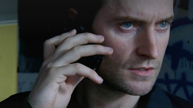 Richard Armitage as Lucas talking on a cell phone in 