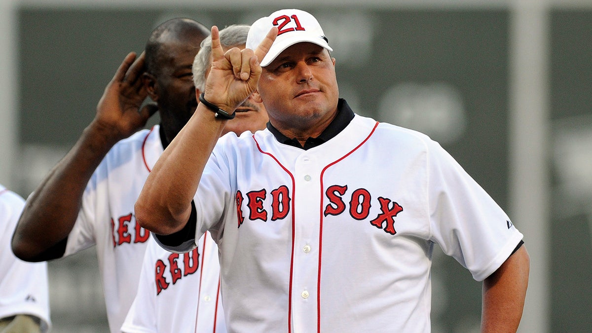 Former Boston Red Sox pitcher Roger Clemens acknowledges fans at Fenway Park.