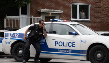A person looks out of a window as police respond to a shooting in the Côte-des-Neiges district of Montreal on Monday, June 22, 2026.