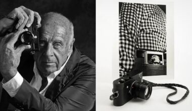 Black-and-white photo showing an older man holding a camera to his eye on the left, and on the right, a camera in front of a photo of a person in a checkered shirt with a photo tucked into their waistband.