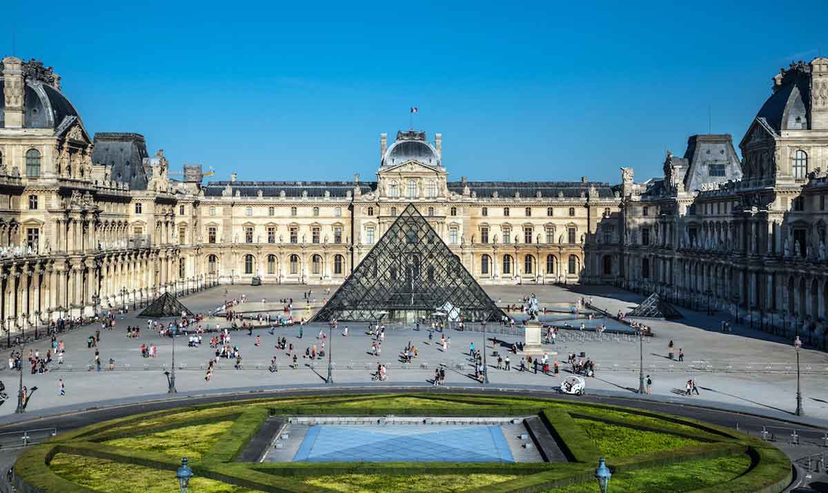 The Louvre Museum in Paris, with its iconic glass pyramid entrance