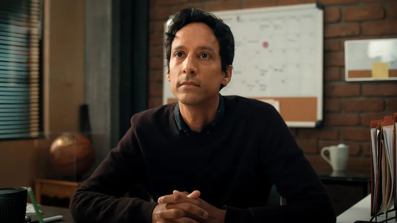 Brad sitting at a desk with hands crossed