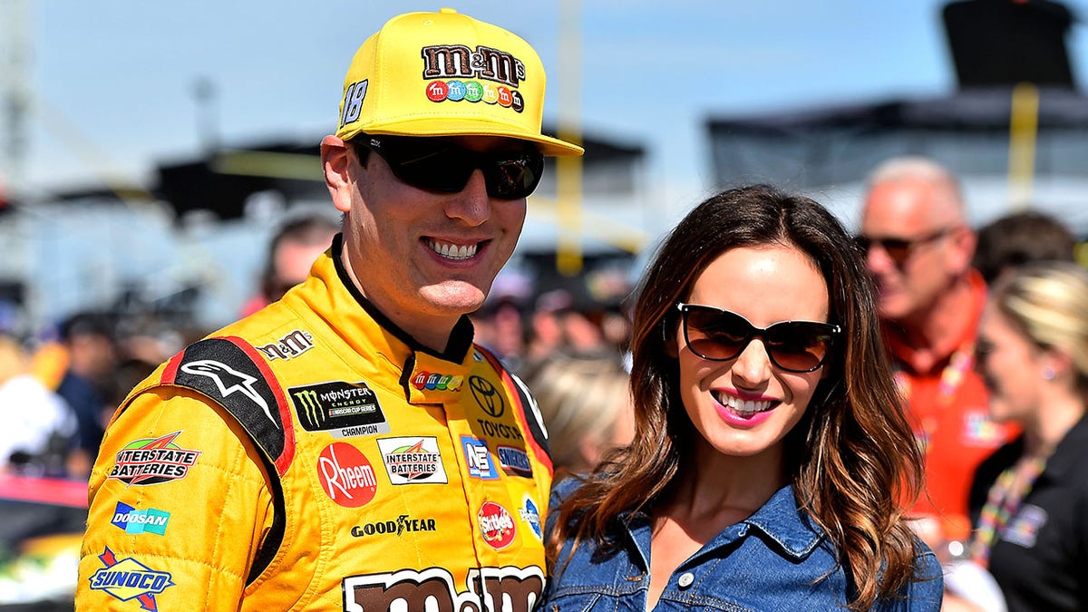NASCAR Cup Series driver Kyle Busch and his wife Samantha standing at Talladega Superspeedway