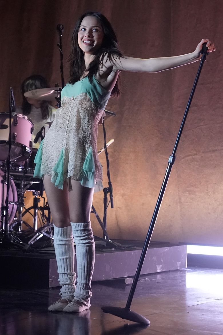 The pop star wore a vintage lace slip — with leg warmers and Miu Miu ballet flats — for a double-duty hosting gig on 