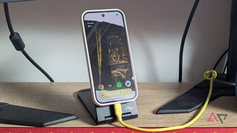 pixel 10 pro on wireless charging stand with yellow charging cable