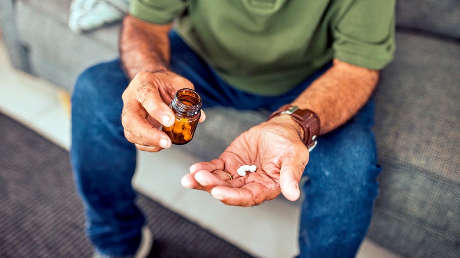 Prescription medication in hand.