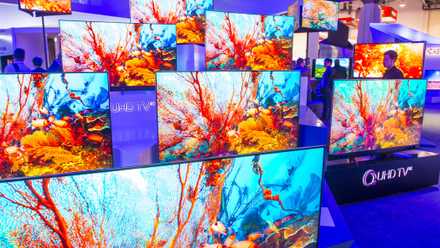 qled tvs on display at tech show.