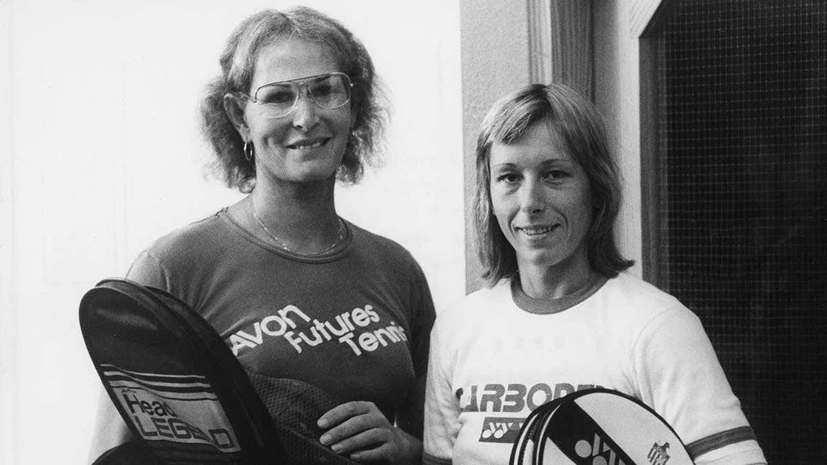 Tennis players Renee Richards and Martina Navratilova holding tennis rackets in protective covers