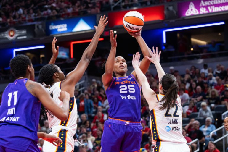Jun 24, 2026; Indianapolis, Indiana, USA; Phoenix Mercury forward Alyssa Thomas (25) shoots the ball while Indiana Fever guard Caitlin Clark (22) defends in the first half at Gainbridge Fieldhouse. Mandatory Credit: Trevor Ruszkowski-Imagn Images