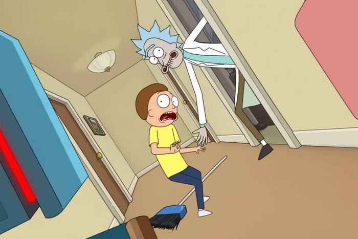 Rick and Morty look panicked in the hallway of their home, as they are pursued by robot enemies
