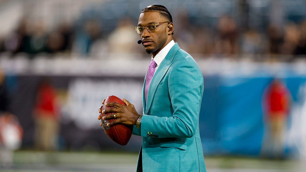 Robert Griffin III standing on the sidelines at EverBank Stadium in Jacksonville