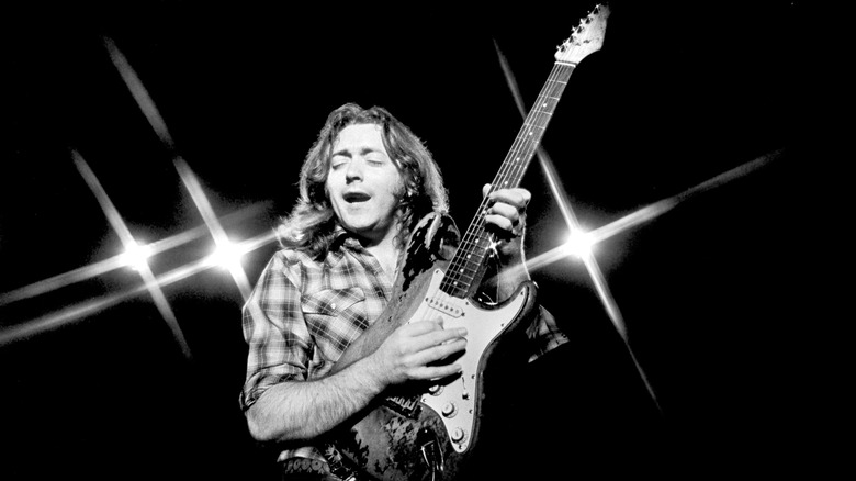 Rory Gallagher onstage with guitar