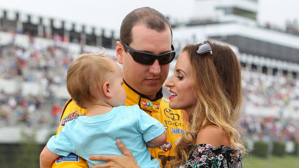 NASCAR driver Kyle Busch standing with his wife Samantha Busch and son Brexton Busch at Pocono Raceway