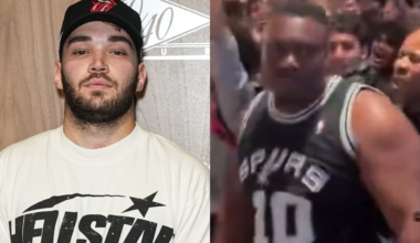 Adin Ross in a white "Hellstar" shirt and cap stands beside another man in a Spurs jersey in a crowded setting.