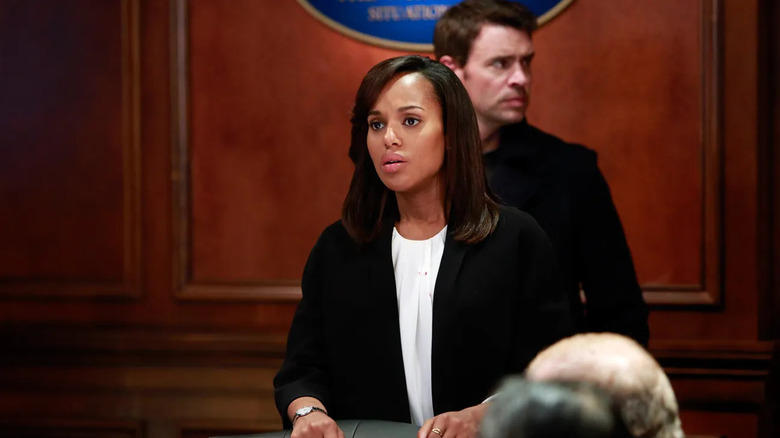 Olivia Pope (Kerry Washington) holds a case while Jake Ballard (Scott Foley) stands behind her in Scandal