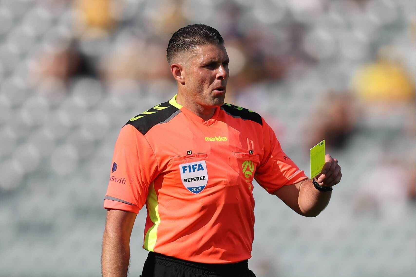 Evans holding a yellow card