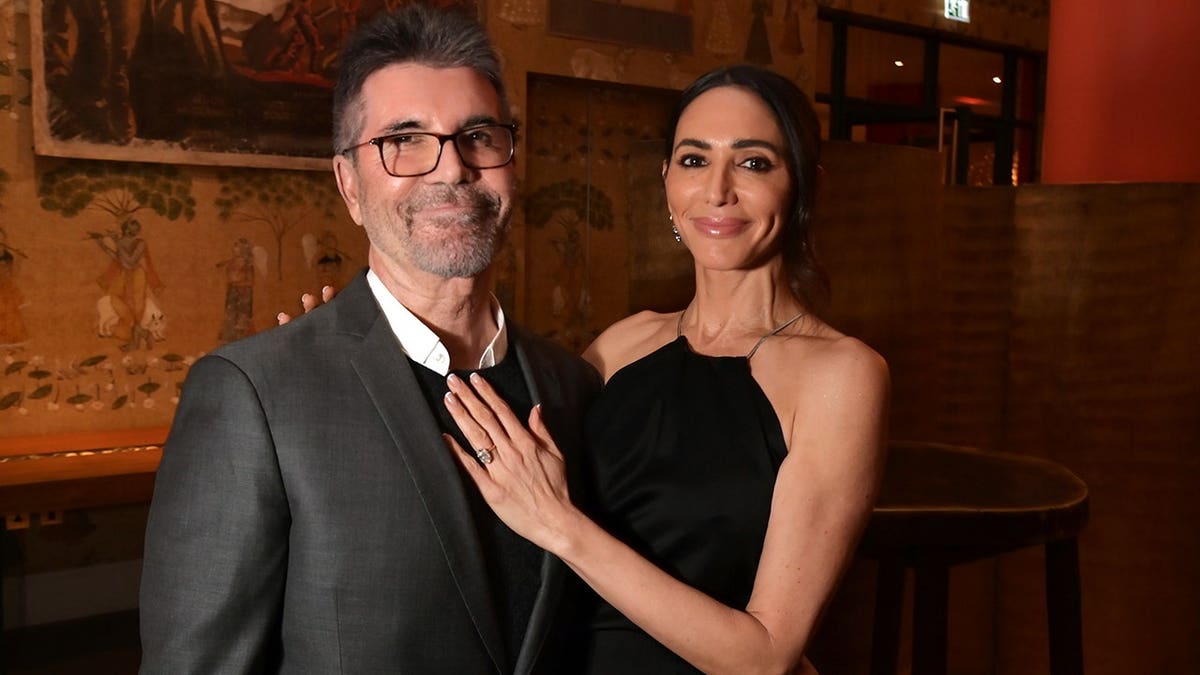 Simon Cowell and Lauren Silverman at the premiere of 