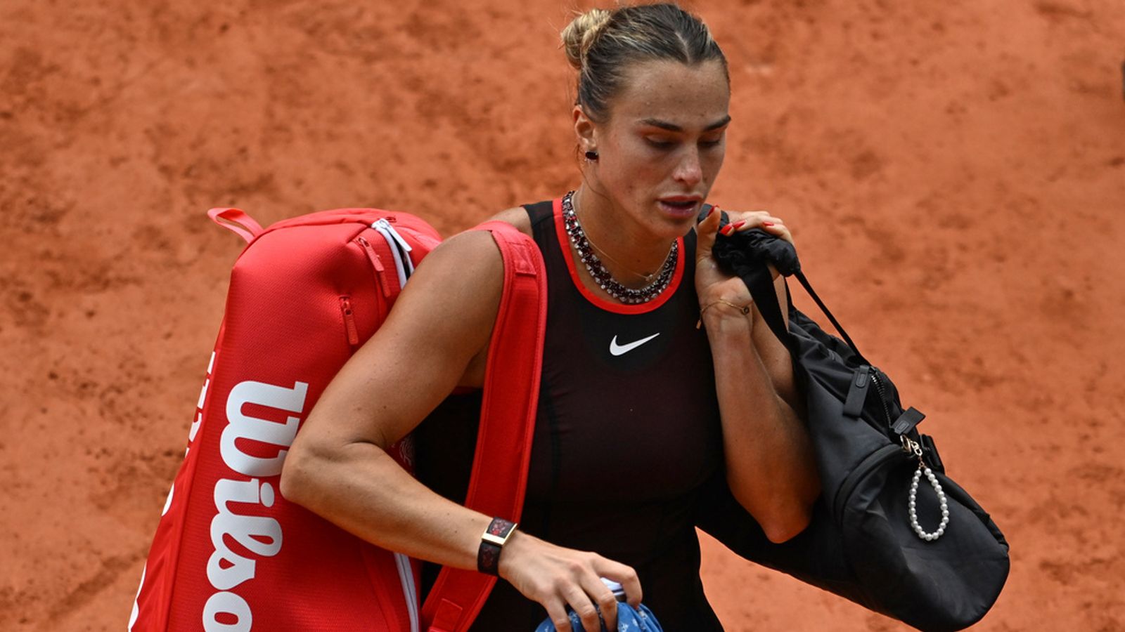 Aryna Sabalenka heads off the court after being beaten by Diana Shnaider