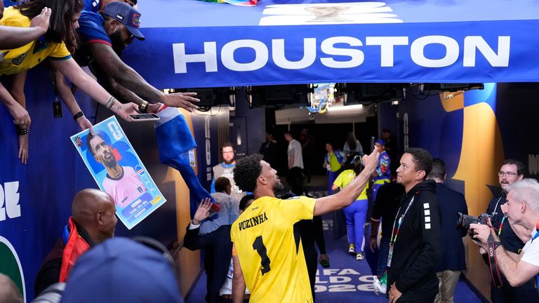 Cape Verde goalkeeper Vozinha takes a selfie with fans after the game against Saudi Arabia