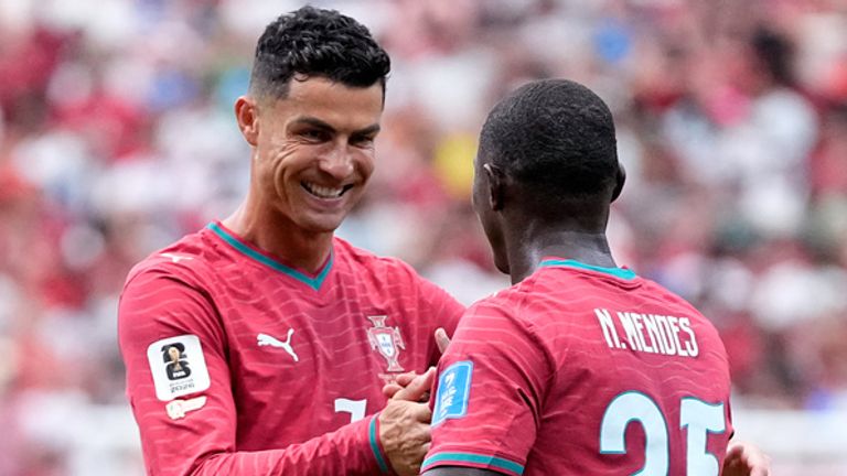 Portugal's Nuno Mendes, right, celebrates with Cristiano Ronaldo after scoring his side's second goal during the World Cup Group K soccer match between Portugal and Uzbekistan in Houston, Tuesday, June 23, 2026. (AP Photo/Ashley Landis)