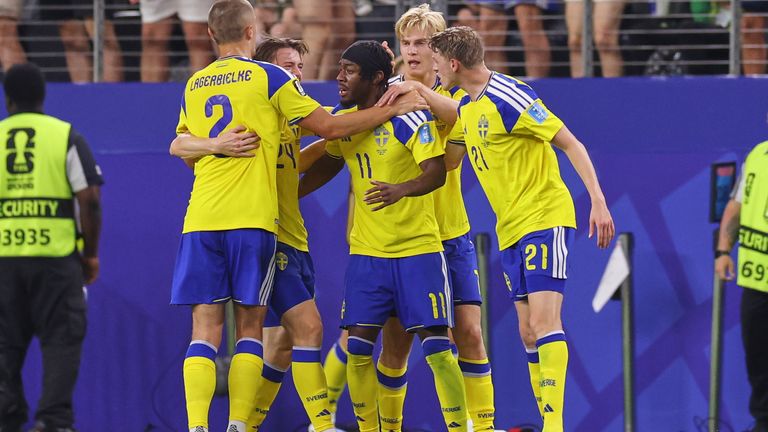 Sweden's Anthony Elanga is congratulated by teammates after scoring