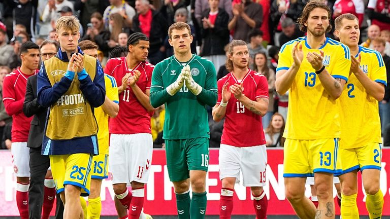 Denmark's and Ukraine's players walk on the pitch after the international friendly soccer match between Denmark and Ukraine was cancelled in Odense, Denmark, Sunday, June 7, 2026, after Christian Eriksen has collapsed on the field again while playing for Denmark...s national team. (Bo Amstrup/Ritzau Scanpix via AP)