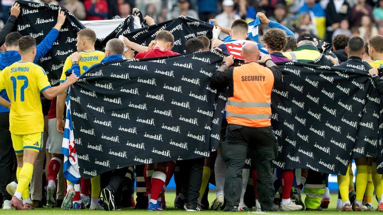 Denmark's and Ukraine's players accompany Christian Eriksen to a waiting ambulance during the international friendly soccer match between Denmark and Ukraine in Odense, Denmark, Sunday, June 7, 2026, after Eriksen has collapsed on the field again while playing for Denmark...s national team. (Bo Amstrup/Ritzau Scanpix via AP)