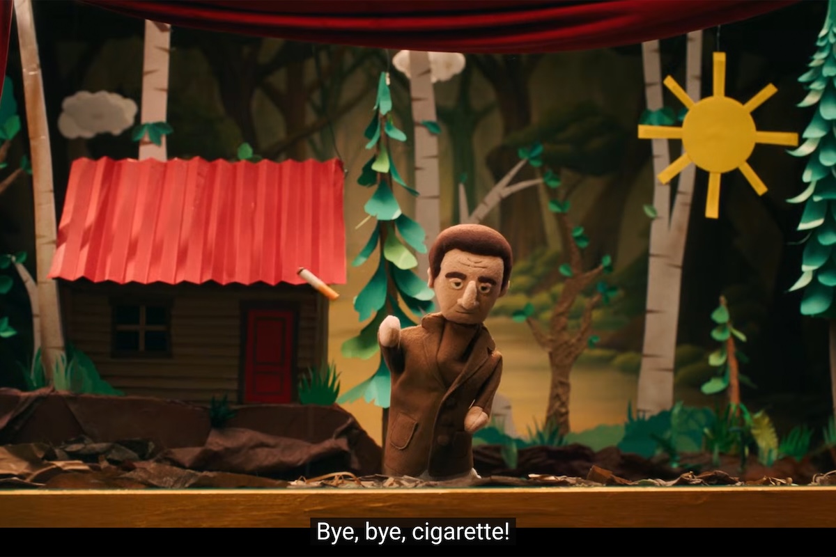 A puppet man in a paper forest throws a cigarette. Caption reads, Bye, bye cigarette!