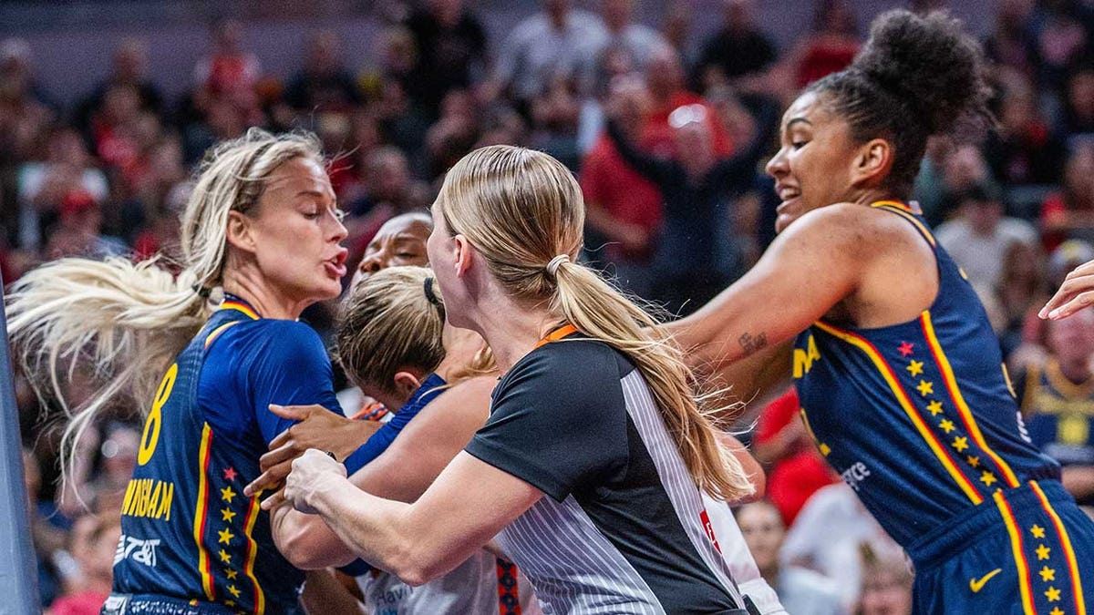 Indiana Fever guard Sophie Cunningham and Connecticut Sun guard Jacy Sheldon fighting on basketball court