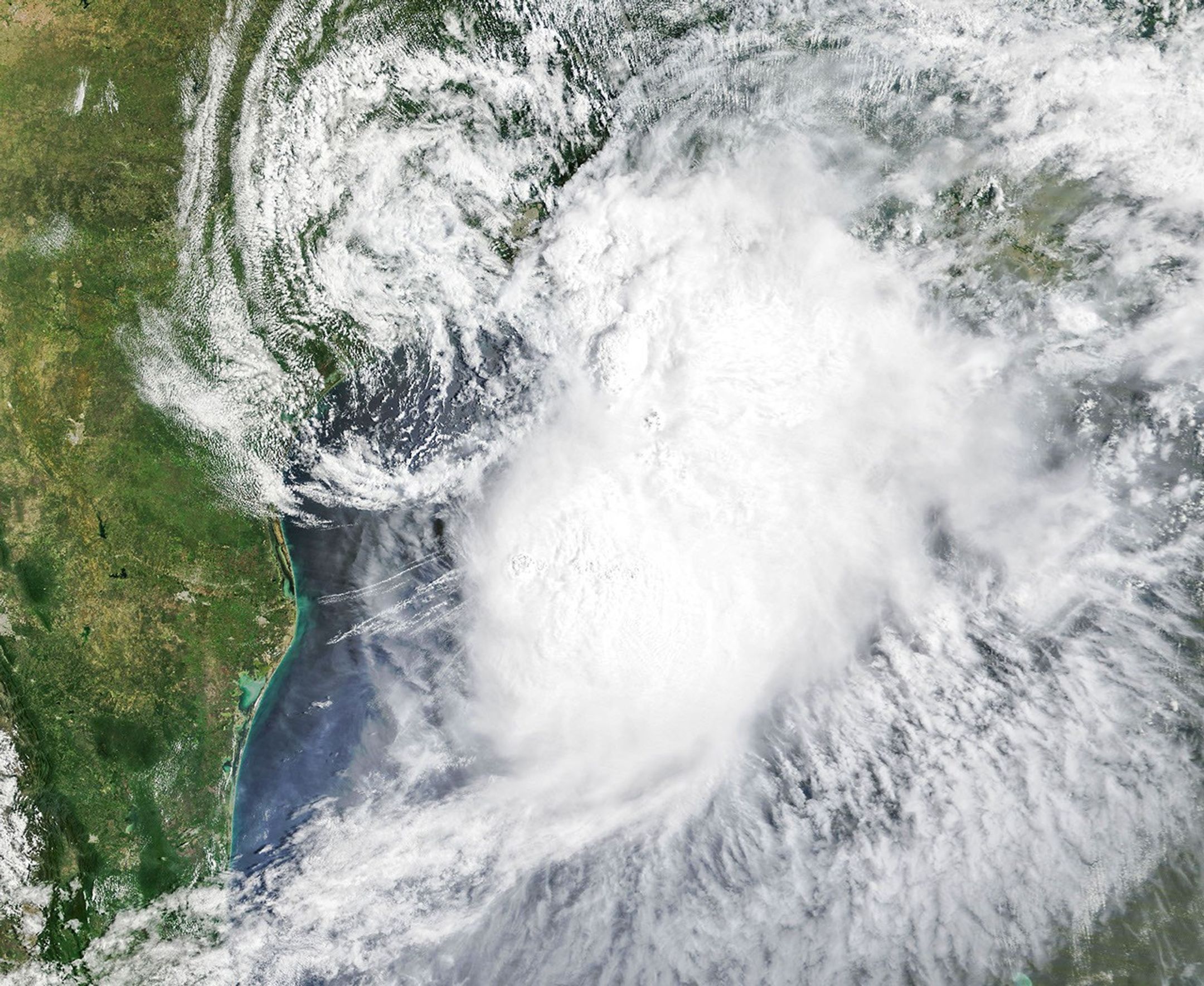 Tropical Storm Arthur’s white storm clouds cover the waters off the U.S. Gulf Coast. Some clouds extend inland over parts of Texas and Louisiana.