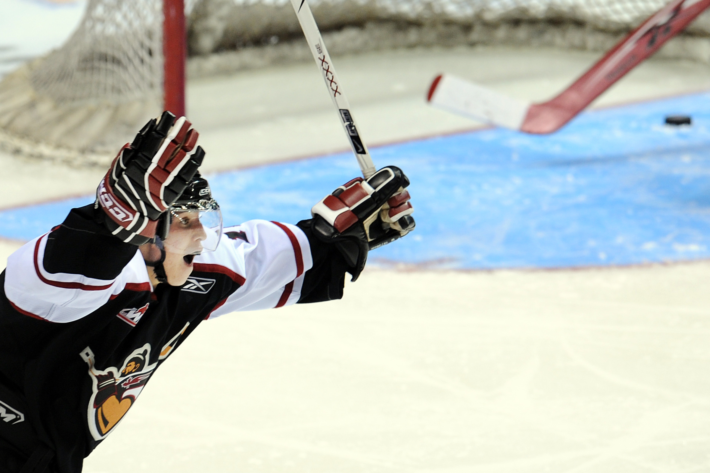 Brendan Gallagher celebrates as the puck is visible in an empty crease behind him.