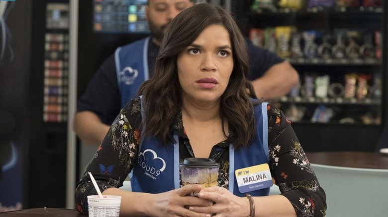 Amy holding a coffee in the break room