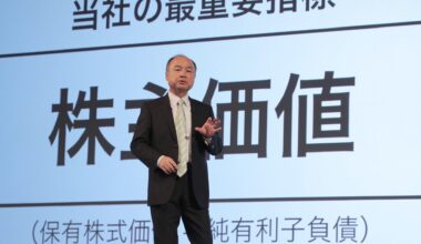 Masayoshi Son speaking in front of a screen with japanese writing