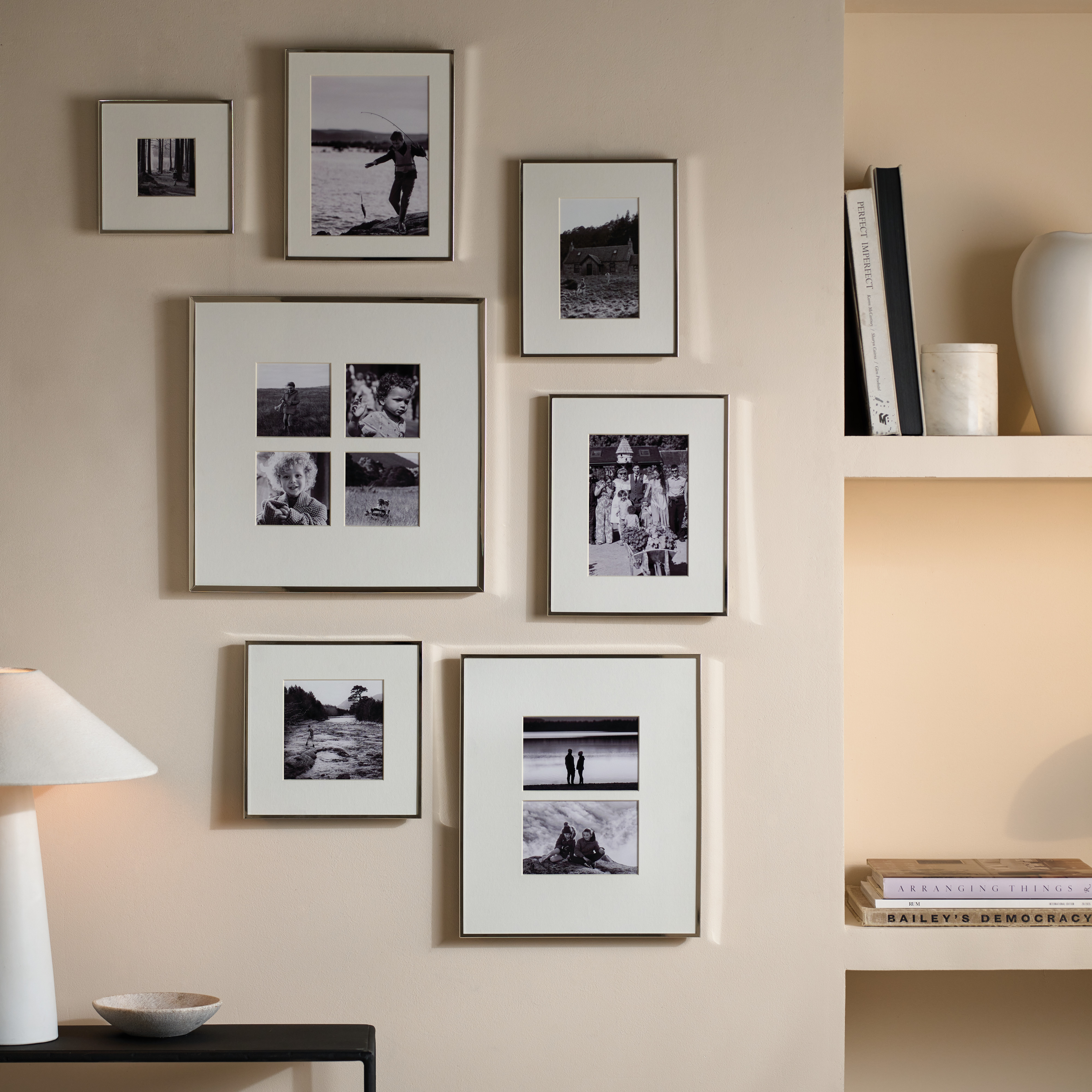 A gallery wall using matching silver frames but in different shapes and sizes