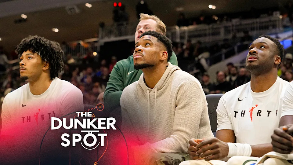 Giannis Antetokounmpo #34, Thanasis Antetokounmpo #43 and Alex Antetokounmpo #29 of the Milwaukee Bucks sit on the bench during the first quarter against the Brooklyn Nets